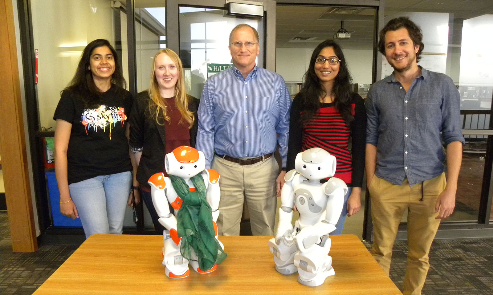Dr. Nielsen with 4 lab members and 2 companionbots