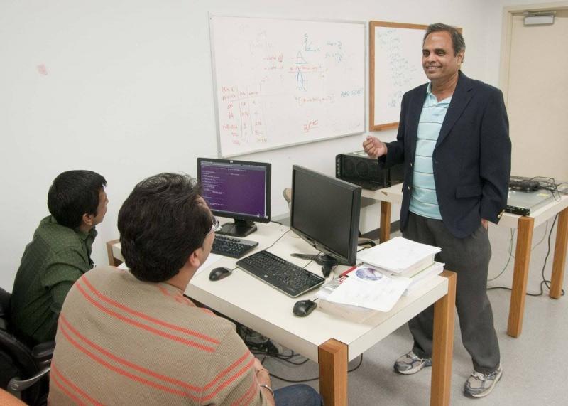Computer Science professor talking with students