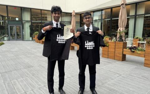 TAMS students holding award and shirts from the 2023 ASSETS Conference